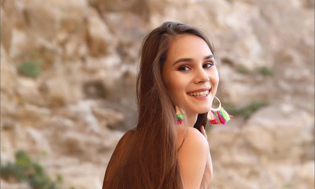 Leona Mia ligt mooi naakt te zijn op de rotsen bij de zee